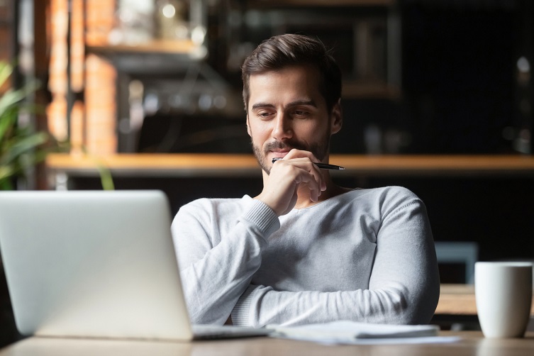 thoughtful_businessman_think_of_online_project_looking_at_laptop_picture